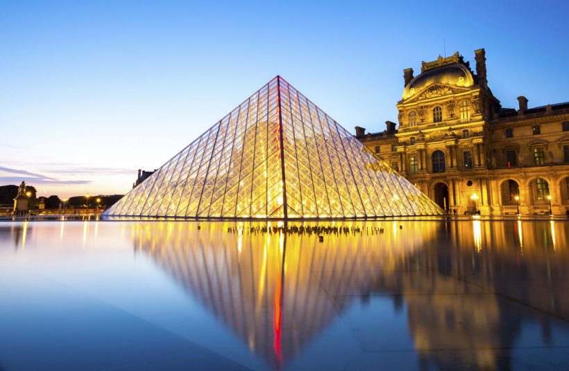 Paris - June 18: Louvre museum at dusk on June 18, 2014 in Paris. This is one of the most popular tourist destinations in France displayed over 60,000 square meters of exhibition space..